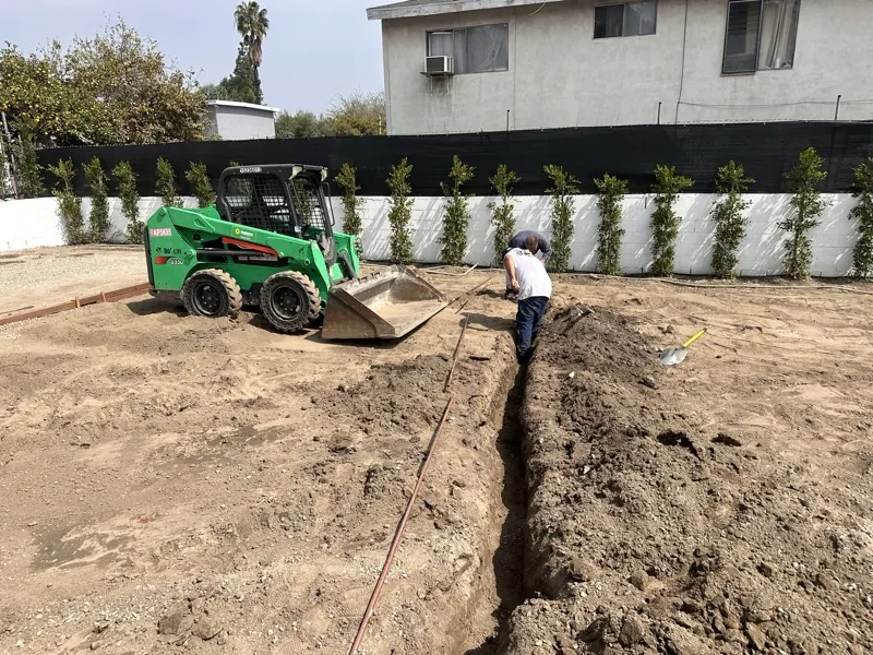 Skid steer and trenching during excavation