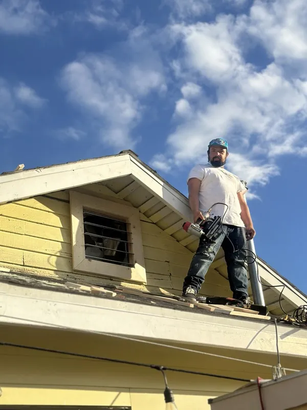 Urbano working on the roof line