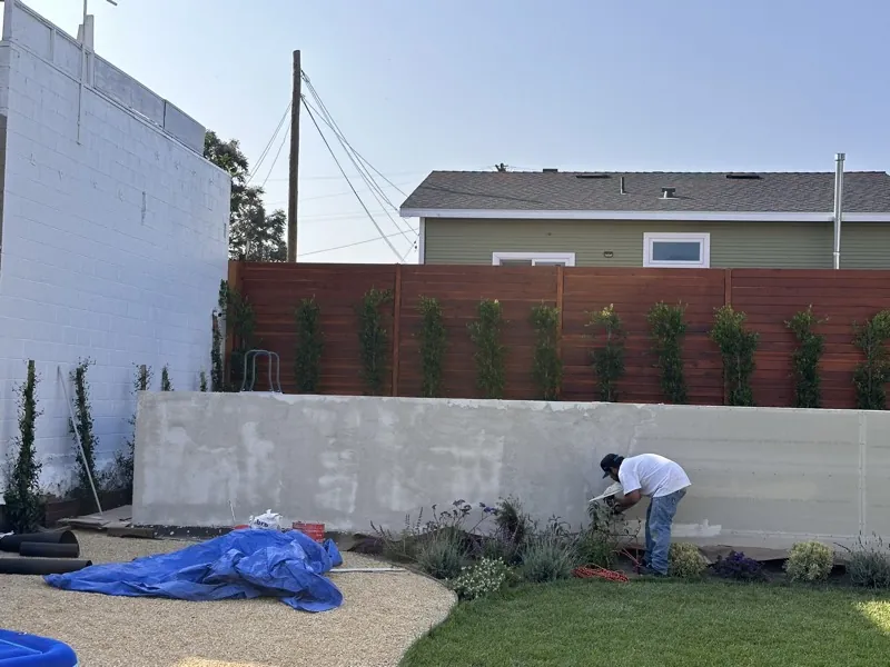 Crew finishing a stucco wall
