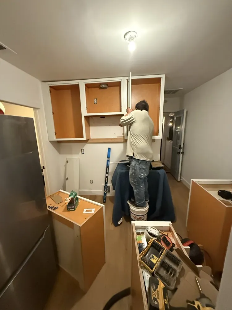 Kitchen before: old cabinets being demoed