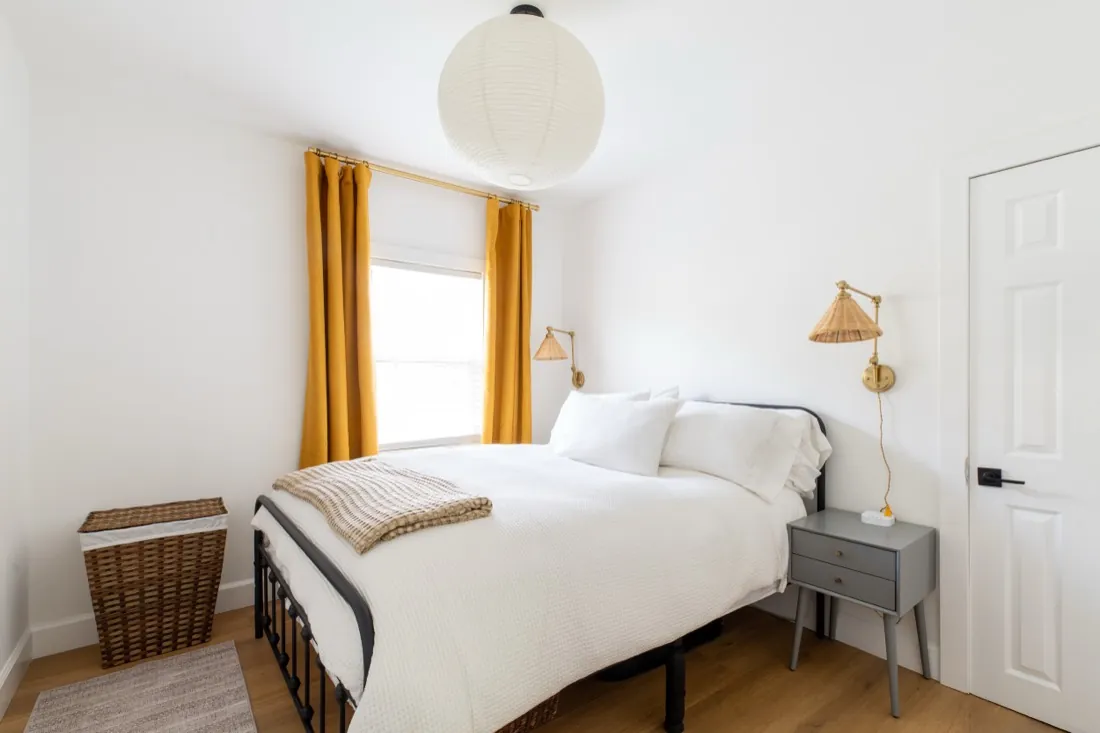 Bedroom with yellow curtains and new flooring