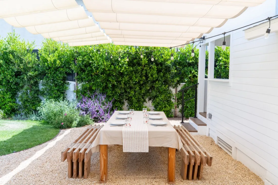 Outdoor dining area under a canopy pergola